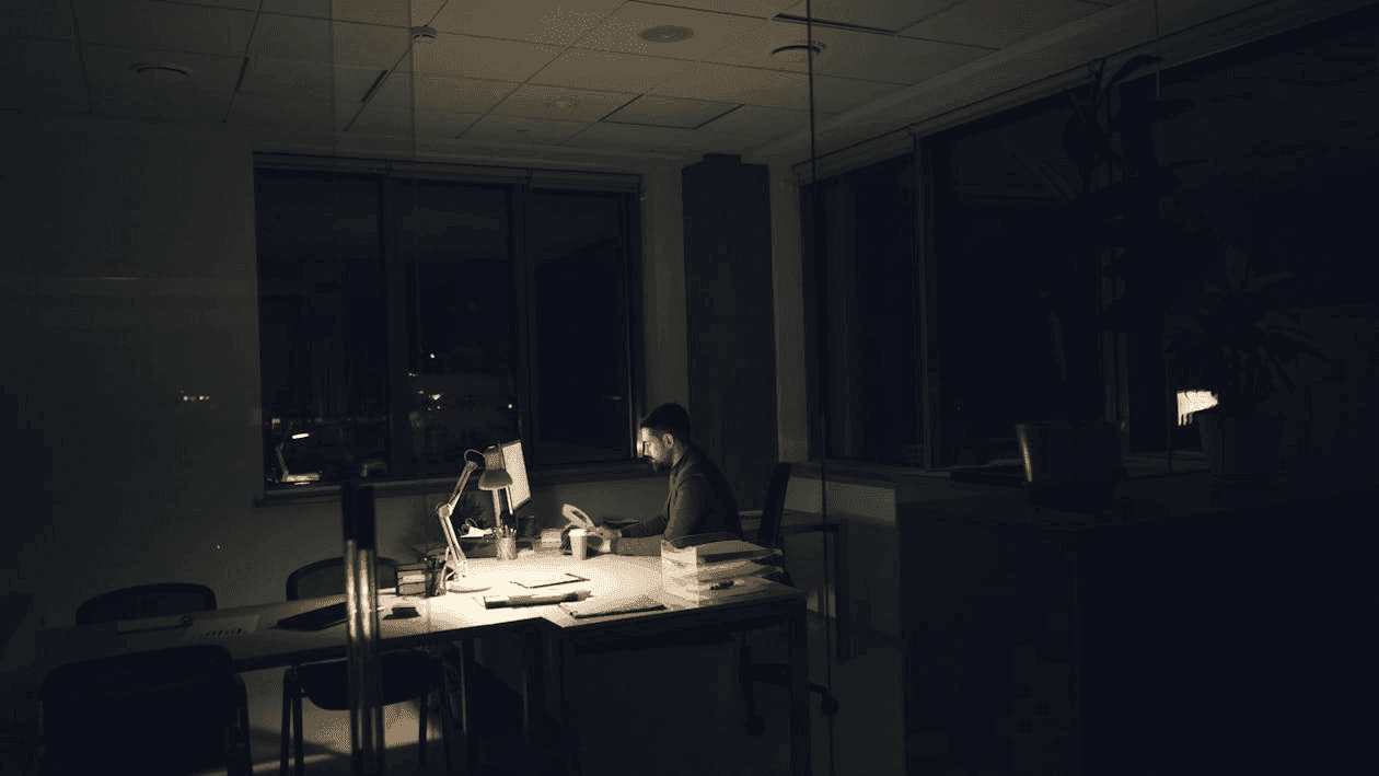 Finance professional working late in a dark office