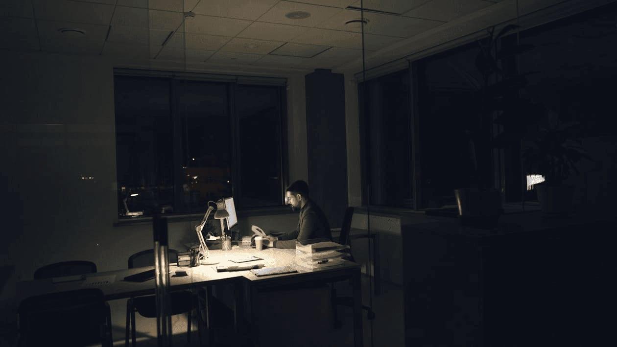 Finance professional working late in a dark office