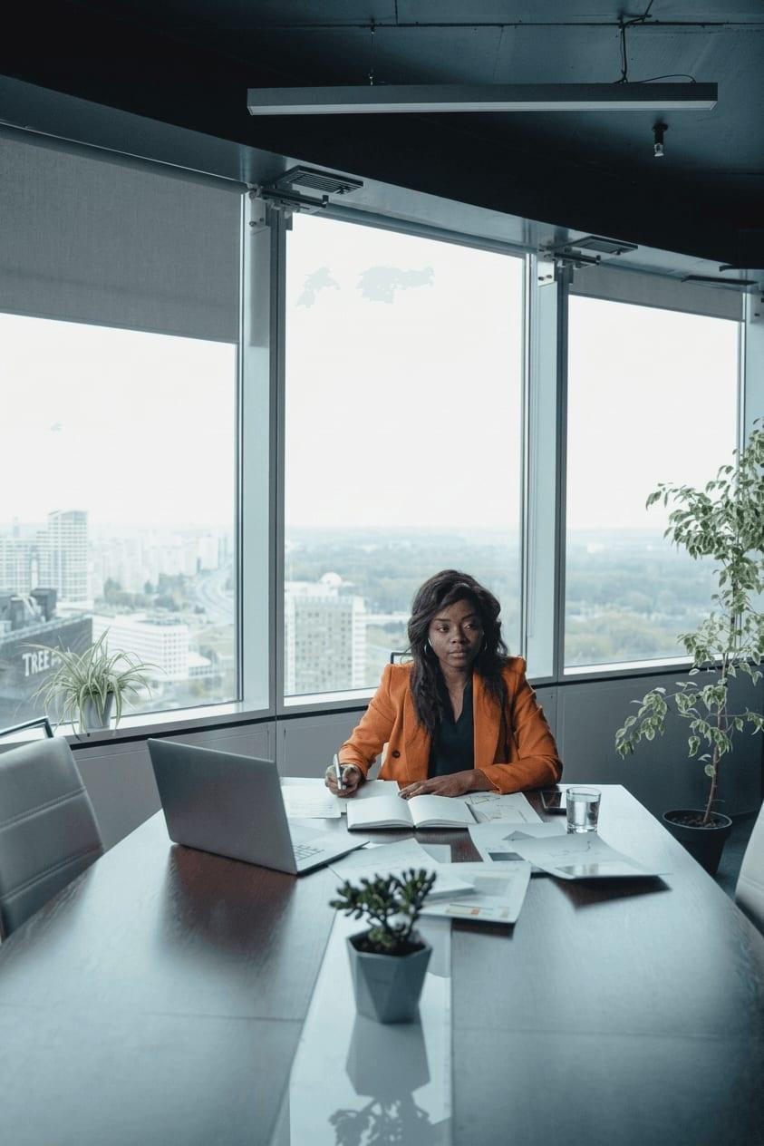 Finance leader reviewing reports in a modern boardroom