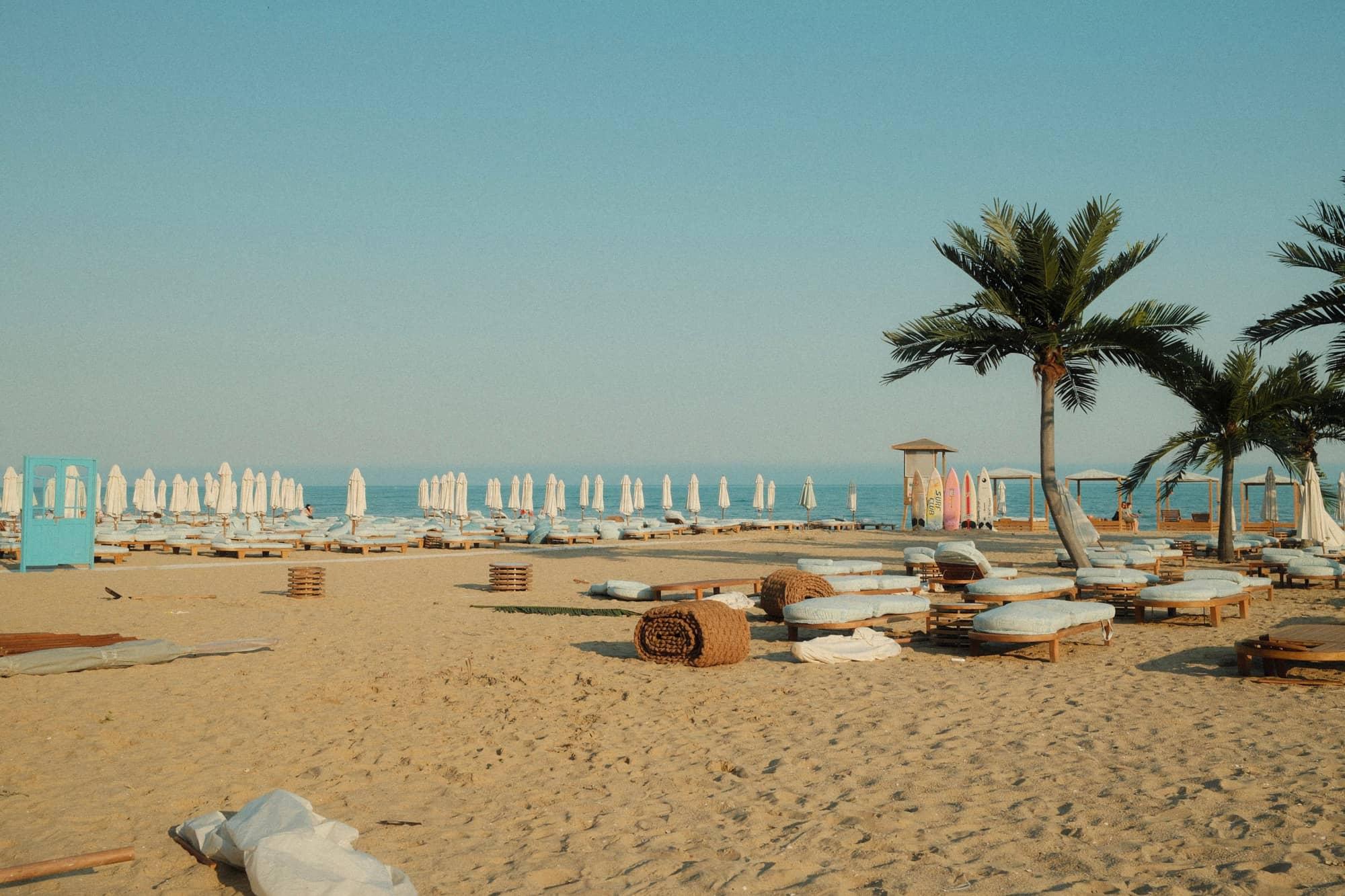 Beachfront resort with sun loungers and palm trees