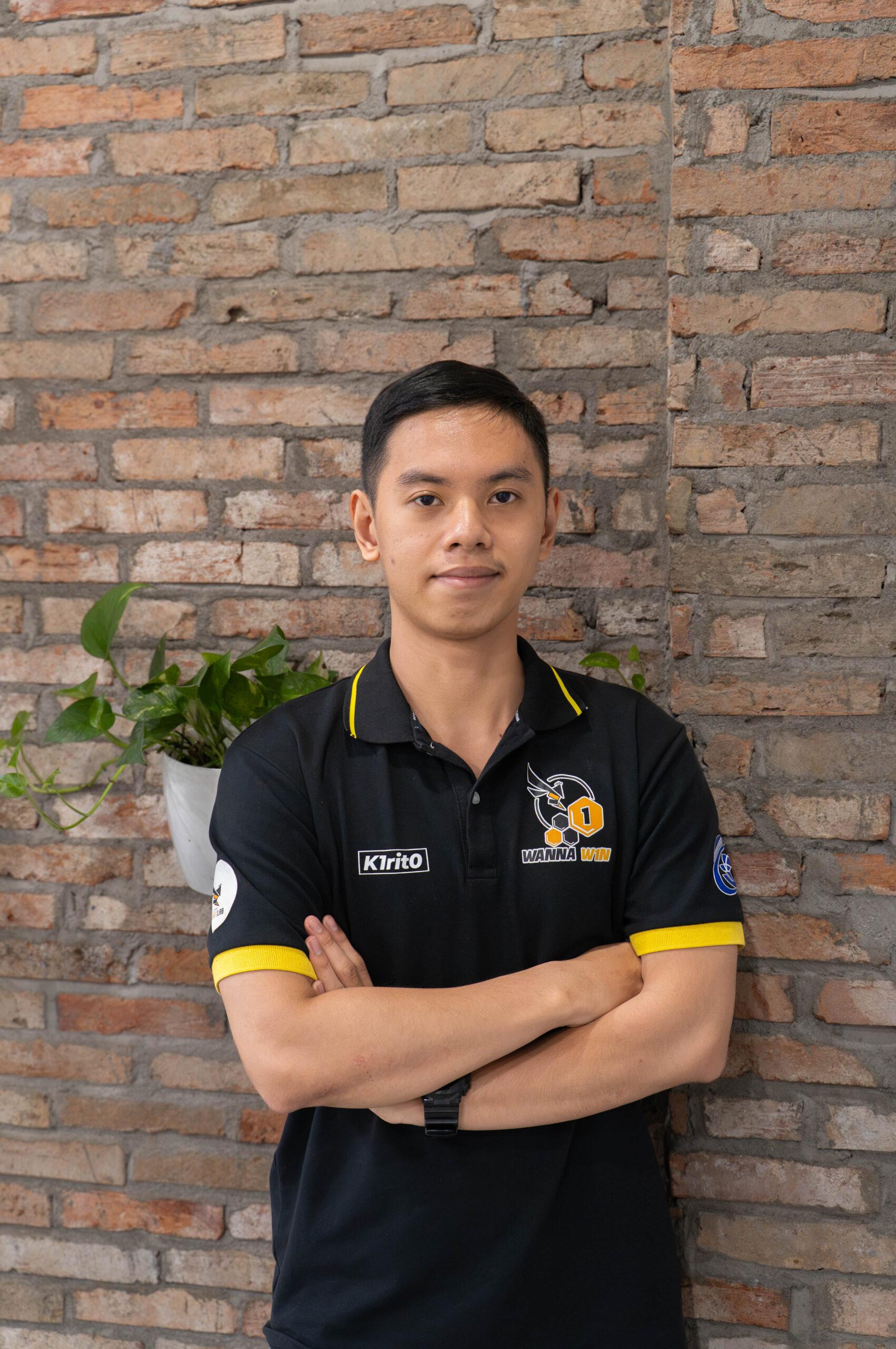 A TRG intern standing in front of a brick wall in the office